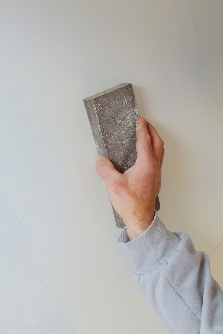 plastering man hand sanding the plaste in drywall seam plasterboard sanding the wall